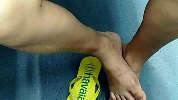 candid brazilian girl playing with flip flops