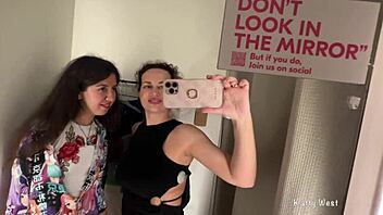 Two horny bitches are kissing in the public locker room with big tits