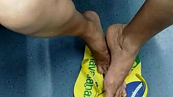 candid brazilian girl playing with flip flops