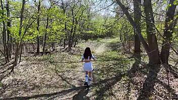 Young girl fishes in the forest after school.