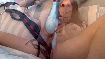 sophie dee lounges around and uses a dildo on her trimmed pussy