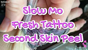 Watch the slow motion of peeling the second skin from a fresh tattoo.