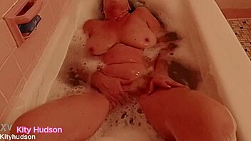 kity hudson enjoys a relaxing bath tub time