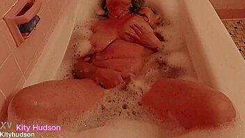 kity hudson enjoys a relaxing bath tub time