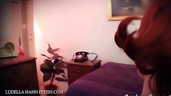 Vintage leather bondage scene with bound woman in retro setting