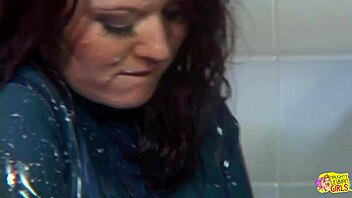 Showering with latex brunette leads to lesbian toy play