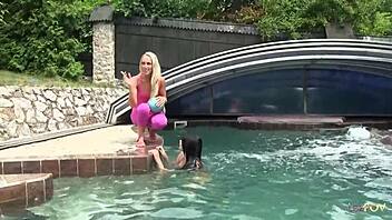 I see playful lesbian teens playing with each other's pussies at the pool