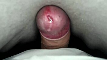 Solo amateur rubs cock under sheets to cumshot orgasm