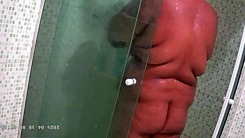 Hidden camera catches chubby milf with big natural tits and ass taking steamy shower