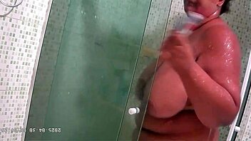Hidden camera catches chubby milf with big natural tits and ass taking steamy shower