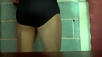 She models her wife's panties in a simple display.