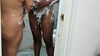 OMG, this lucky asian guy is showering with a busty ebony milf and her huge natural tits!