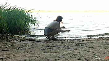 Whoa, how does teen redhead Mia hit such a wild orgasm fingering beside the lake?