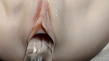fake cock slides into her shaved pussy for double penetration fun