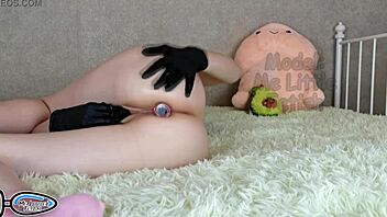 A skinny college student in latex gloves uses a butt plug for close-up solo play