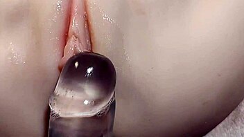 fake cock slides into her shaved pussy for double penetration fun