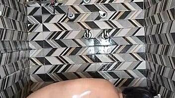 Muscular housewife with big ass and tits gives deepthroat blowjob in bathroom, then dances and fingers for cum in mouth with husband.