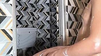 Muscular housewife with big ass and tits gives deepthroat blowjob in bathroom, then dances and fingers for cum in mouth with husband.