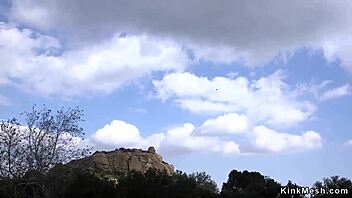 Natural huge tits slave endures rough anal fucking with bondage and bizarre fetish elements outdoors.