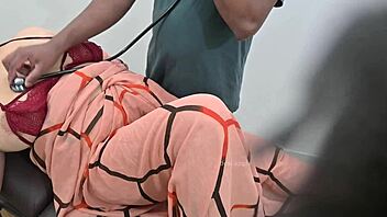 Indian doctor examines lady patient thoroughly in the clinic setting