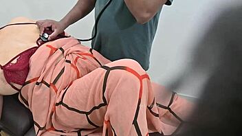 Indian doctor examines lady patient thoroughly in the clinic setting