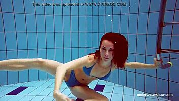 martina slips into a blue bikini for an underwater swim showing her tight european body in the pool