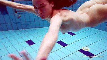 martina slips into a blue bikini for an underwater swim showing her tight european body in the pool