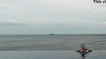 Chatting about relaxing by the infinity pool with scenic views