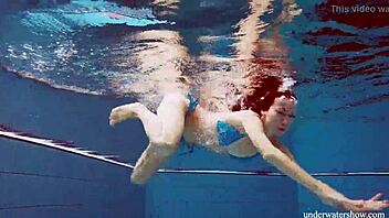 martina slips into a blue bikini for an underwater swim showing her tight european body in the pool