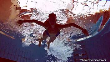 martina slips into a blue bikini for an underwater swim showing her tight european body in the pool