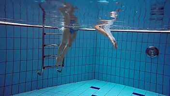 martina slips into a blue bikini for an underwater swim showing her tight european body in the pool