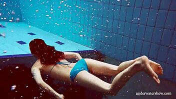martina slips into a blue bikini for an underwater swim showing her tight european body in the pool