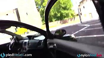 Brunette in black pantyhose shows off her feet from her car, wanna see this fetish tease?!