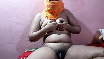 Woman reveals her large breasts in a seductive display