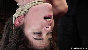 I see this brunette in one leg inverted suspension getting choked and whipped roughly