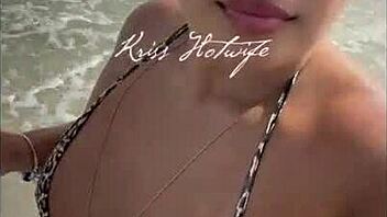 hey, check out this married hooker flaunting her huge ass in tiny bikini on the beach?