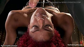 In a kinky session, redhead ebony faces intense gangbang BDSM training with bondage, choking, deepthroat, gagging, whipping, and rough interracial submission.