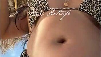 hey, check out this married hooker flaunting her huge ass in tiny bikini on the beach?