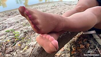 Hey, my cute feet in nude tights rub together teasingly on the autumn river bank outdoors