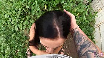 Horny brunette student delivers sloppy blowjob and swallows cum behind the garages in public