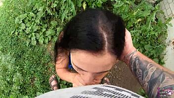 Horny brunette student delivers sloppy blowjob and swallows cum behind the garages in public