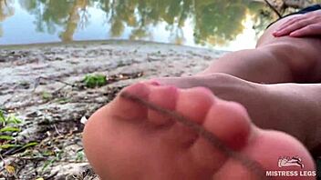 Hey, my cute feet in nude tights rub together teasingly on the autumn river bank outdoors
