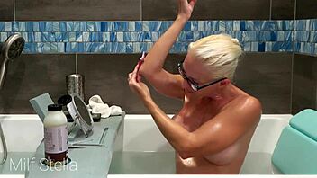 Why does Milf Stella's solo bath turn into a steamy pussy and body shaving fetish session