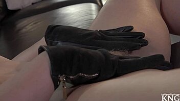 She casually slips on gloves to indulge her fetish desires, building toward a satisfying climax in the scene