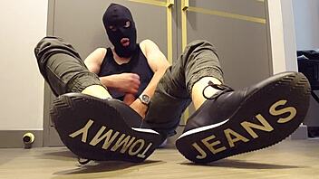 Guy masturbates while wearing sneakers
