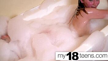 Petite redhead babe masturbates wet pussy in bath