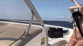 attractive blonde in lingerie enjoys time with captain on boat