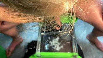 mature milf gives sensual handjob leading to cumshot in aquarium setting with muscular bodybuilder vibes.