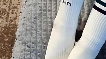 In the dorm room a cute petite girl next door bought special socks to playfully tease her roommate's interest