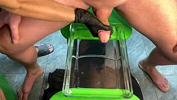 mature milf gives sensual handjob leading to cumshot in aquarium setting with muscular bodybuilder vibes.